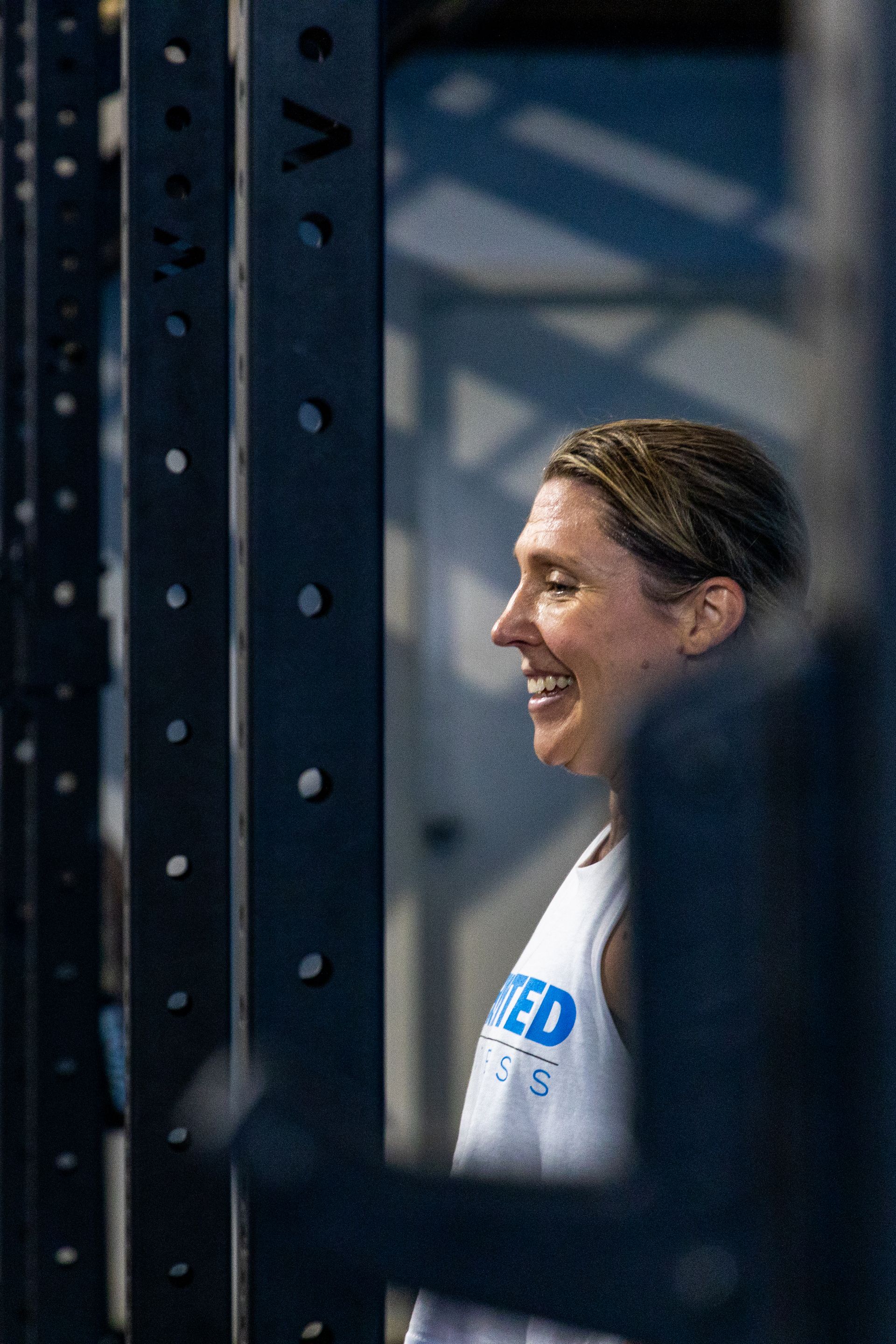 woman smiling as she exercises — Functional, Strength And Conditioning Gym in Gold Coast, QLD