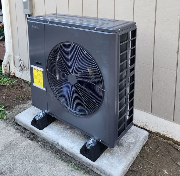 Technician repairing outdoor heat pump unit to restore heating and cooling performance