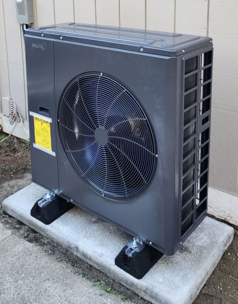 Technician repairing outdoor heat pump unit to restore heating and cooling performance