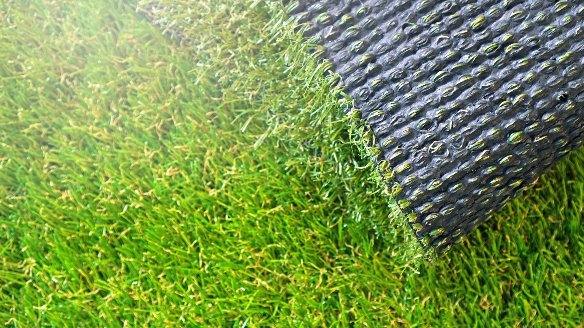 A stack of grass rolls on a wooden pallet.