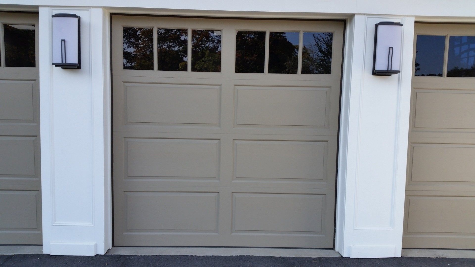 symmetrical garage door with windows in Old Westbury, NY - Regina Door & Design Corp