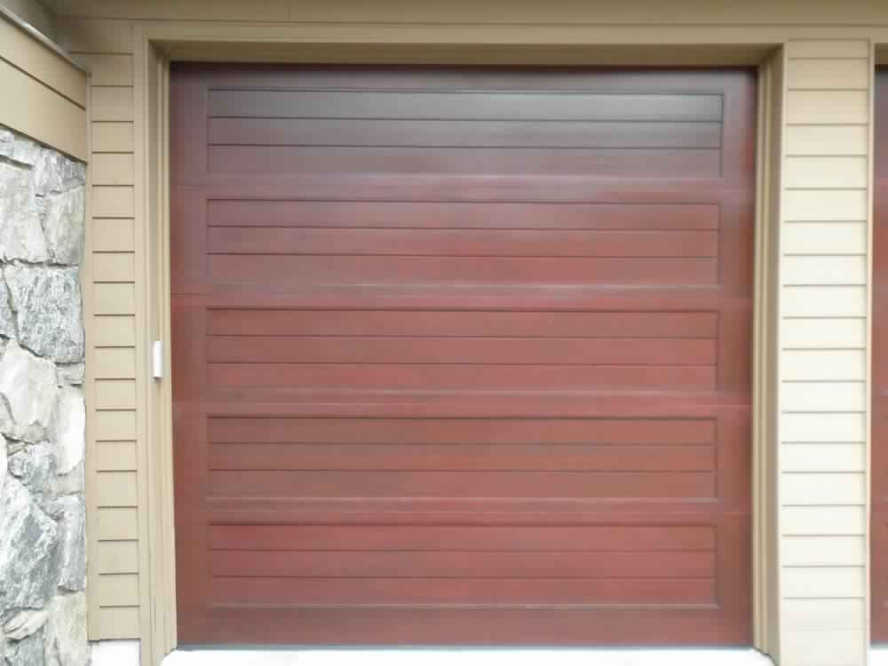 dark wood garage door installation in Upper Brookville, NY - Regina Door & Design Corp