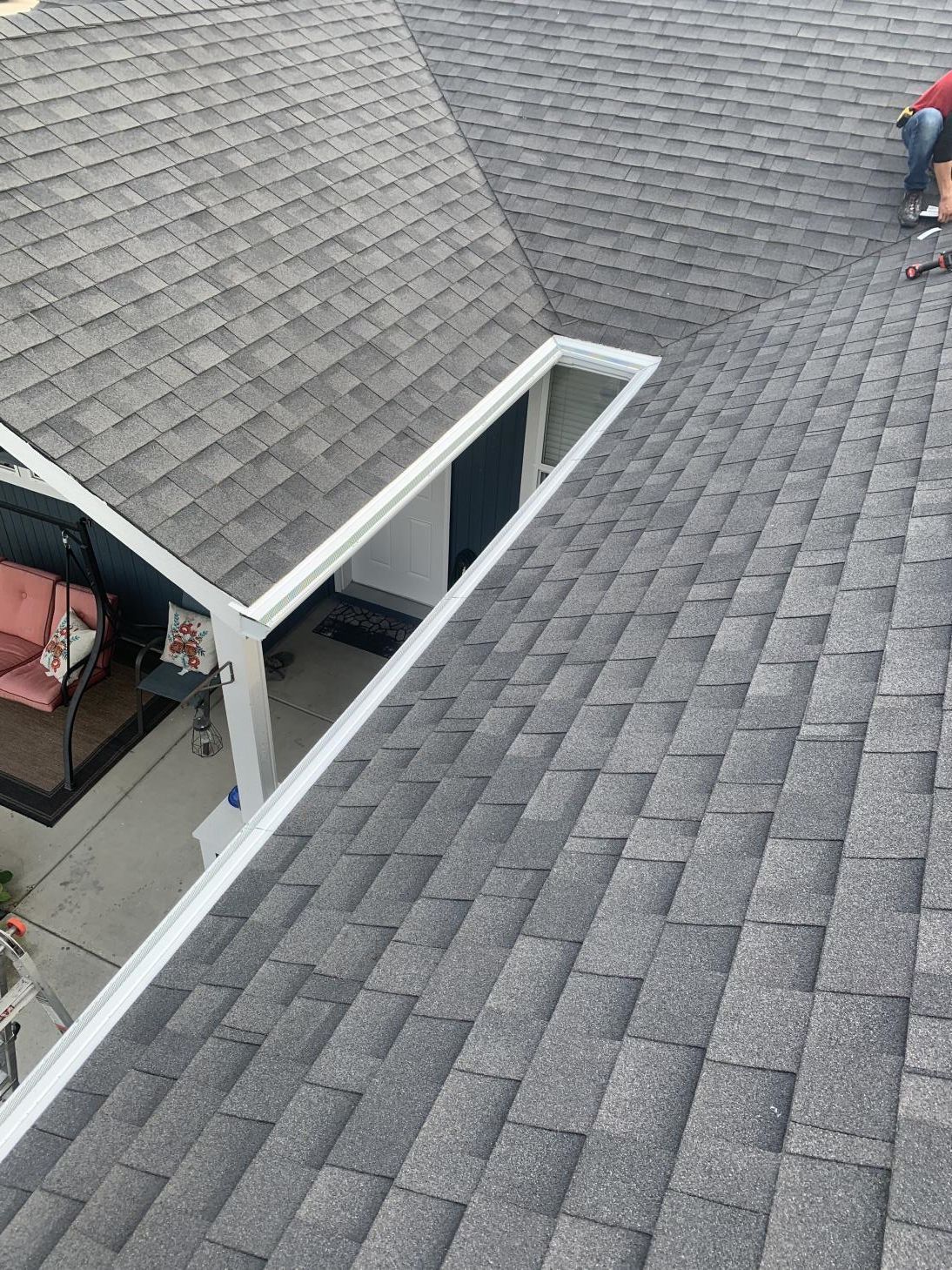 A close-up view of a roof gutter system installed along the edge of a house.