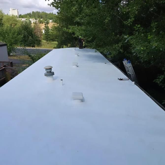 A close-up view of a roof gutter system installed along the edge of a house.