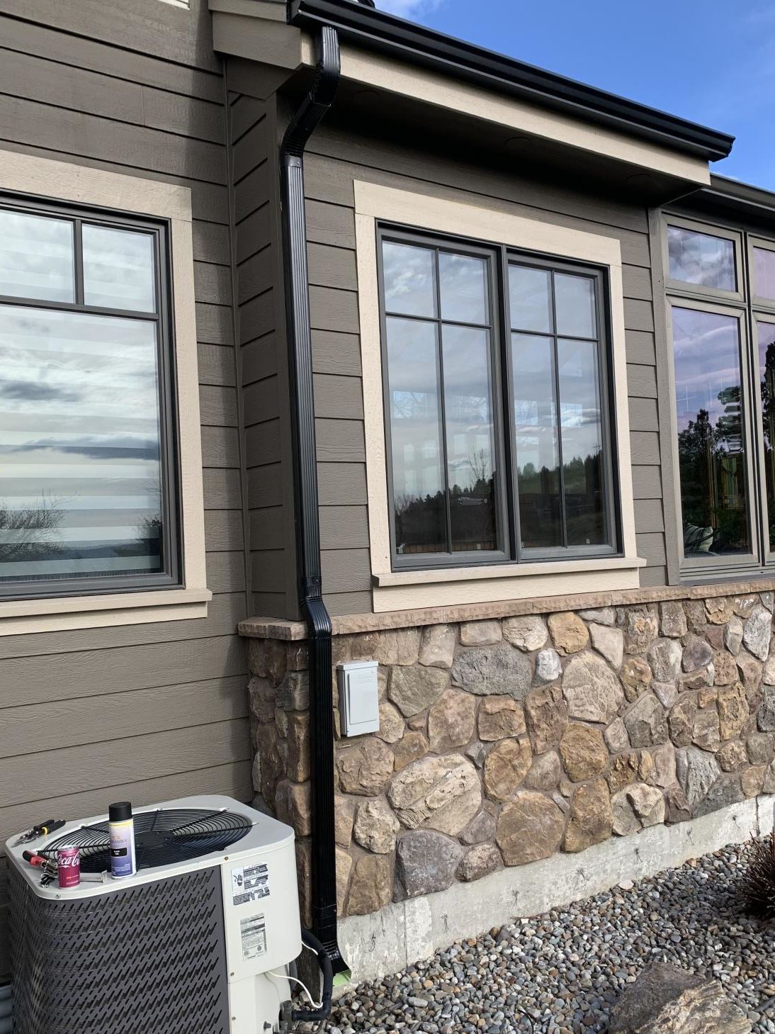 A close-up view of a roof gutter system installed along the edge of a house.