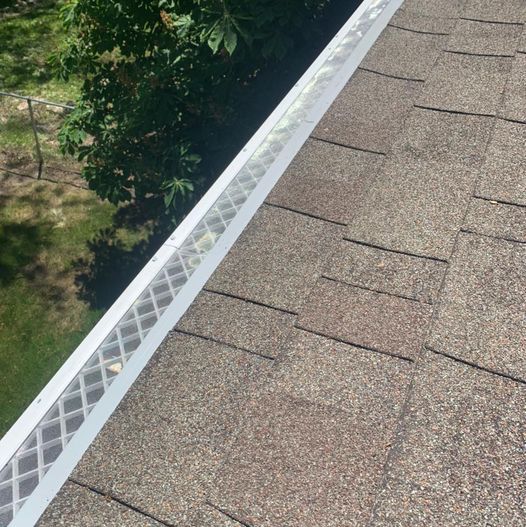An image showcasing the installation process of a gutter guard system.