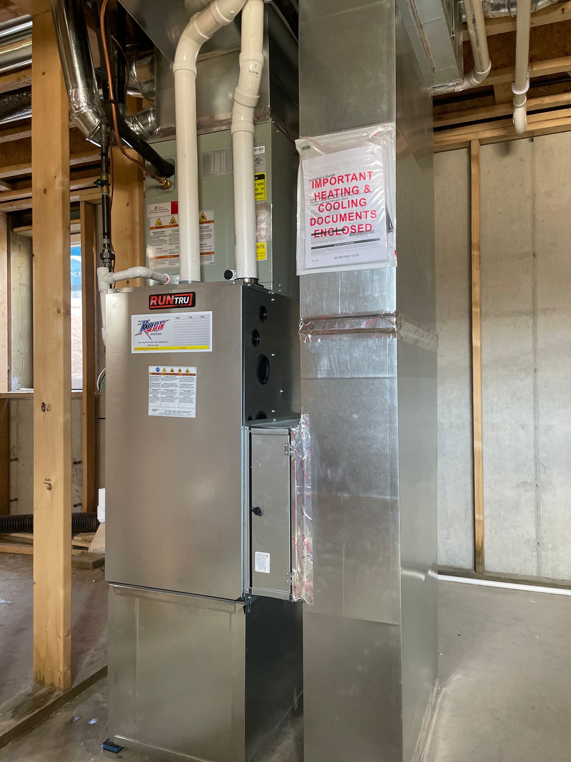 A picture of a heating and cooling system in a house under construction.