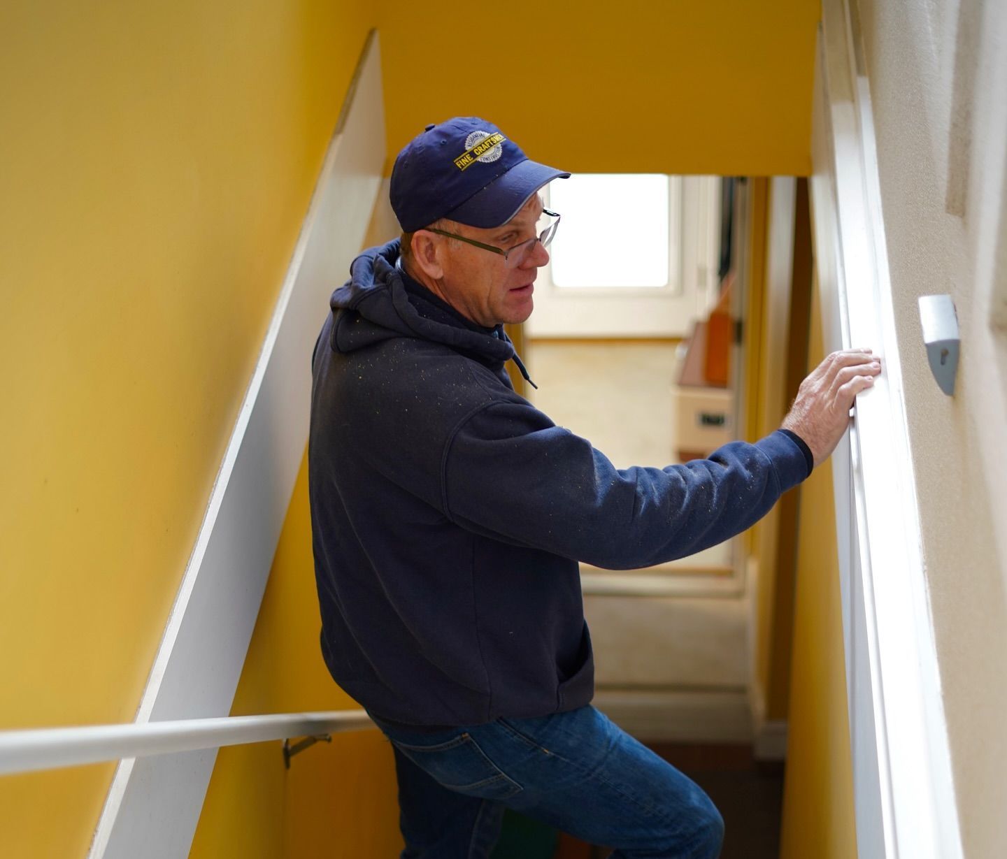 Nick Dewey inspecting work on house