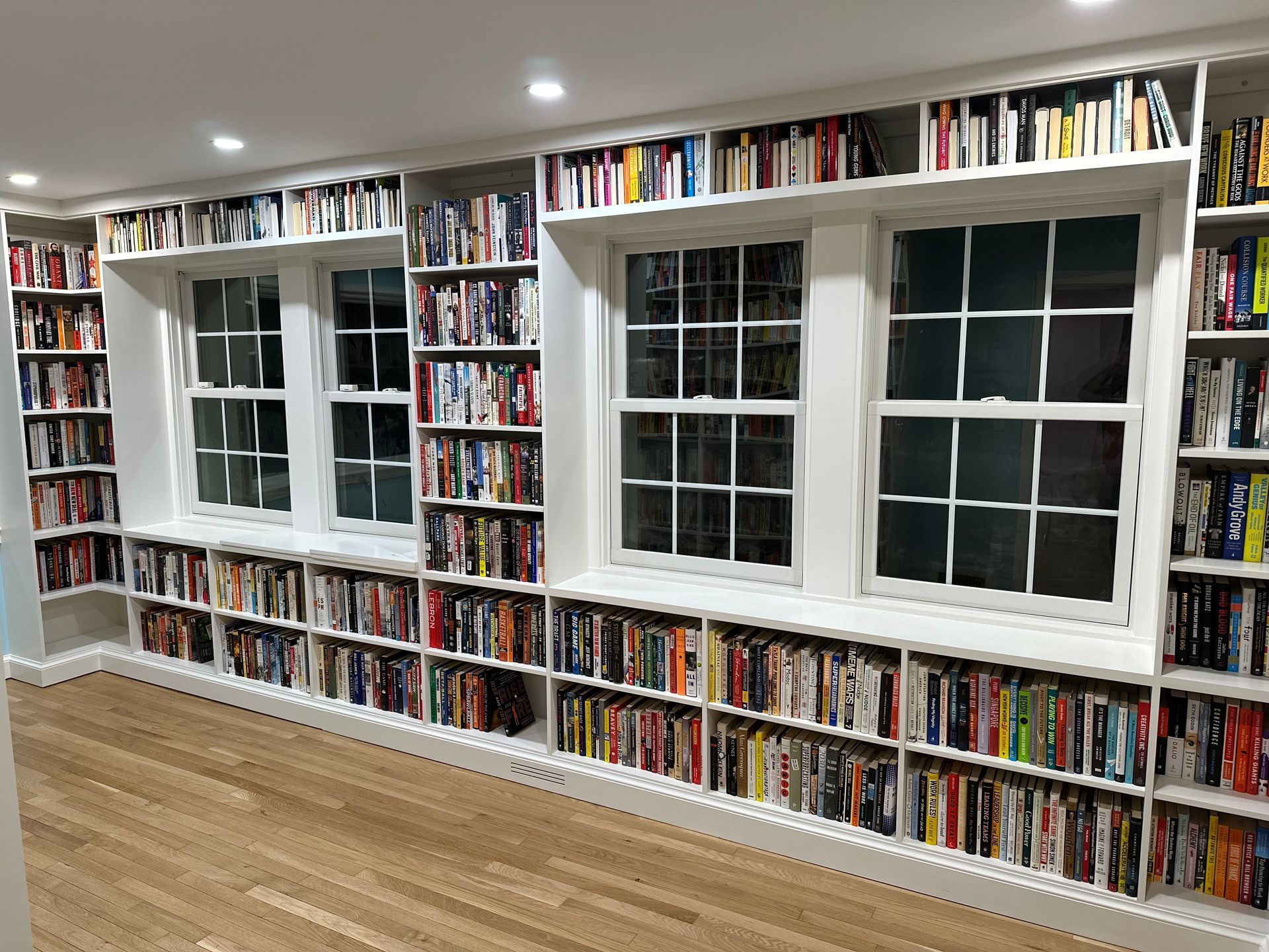 A full wall custom shelving with lots of books.