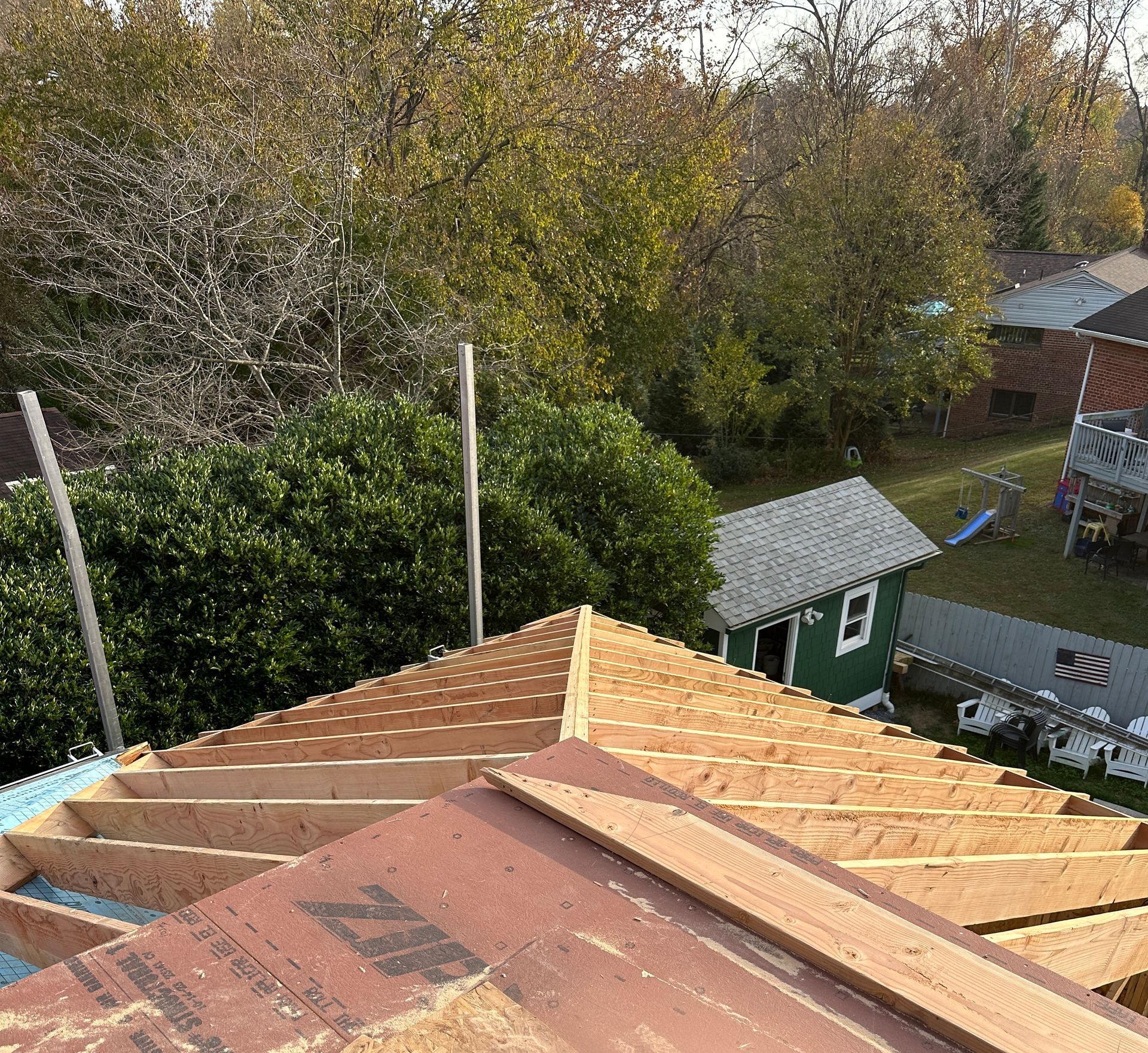 An aerial view of a house under construction with a zip roof