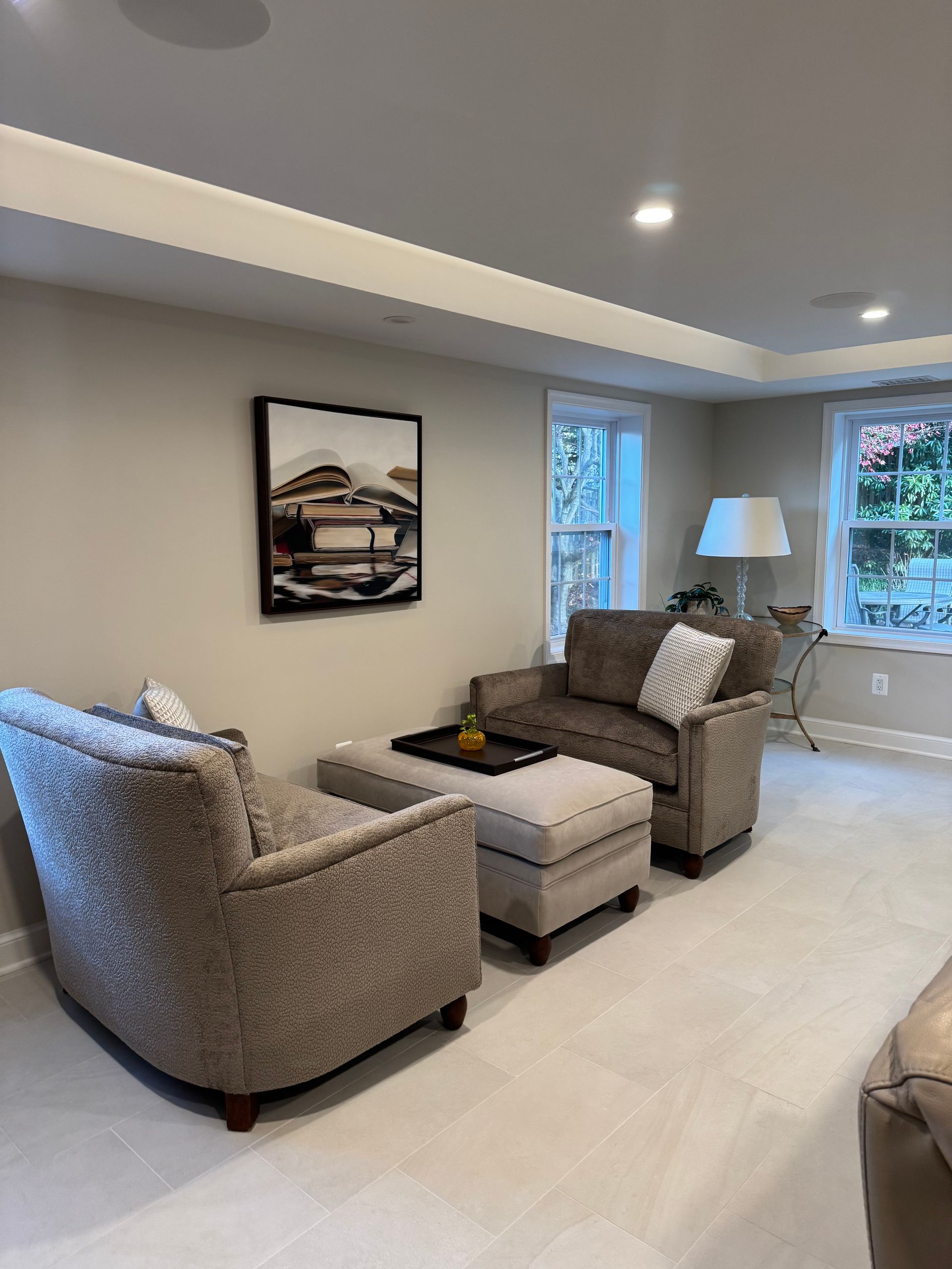 A living room with a couch and two chairs