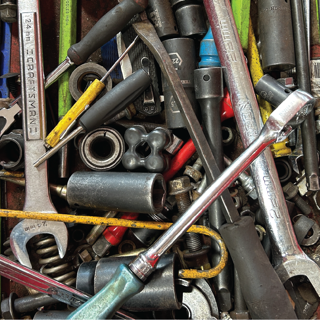 Assorted tools, including wrenches, sockets, and screwdrivers, in a toolbox.