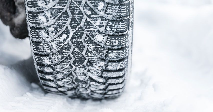 Snow covered tire on a snow covered road