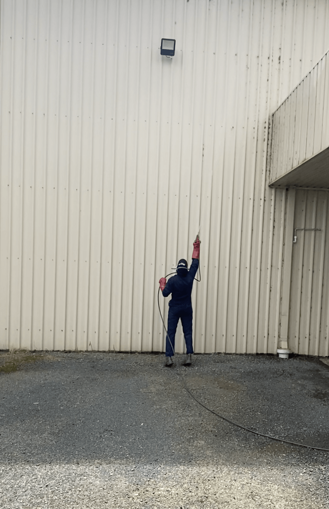 Technician wearing PPE and spraying property — Professional Pest Control In Thurgoona NSW