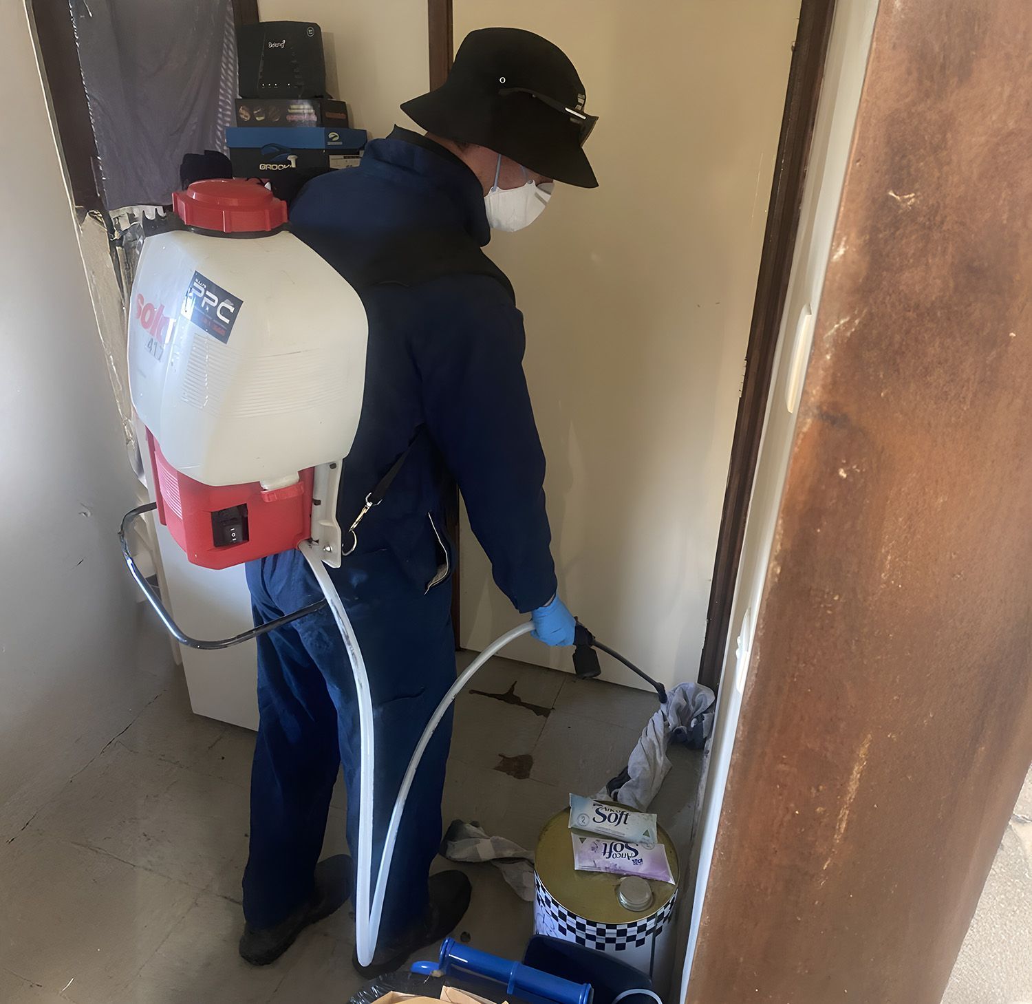 A Person In Protective Gear Disinfecting A Room