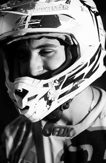 A black and white photo of a man wearing a fox helmet