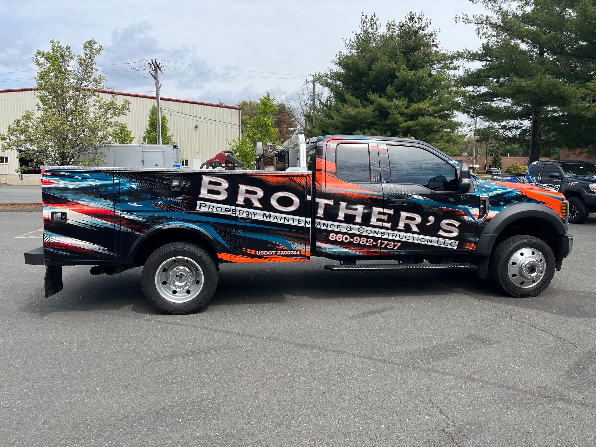 A truck with the word brother 's on the side is parked in a parking lot.