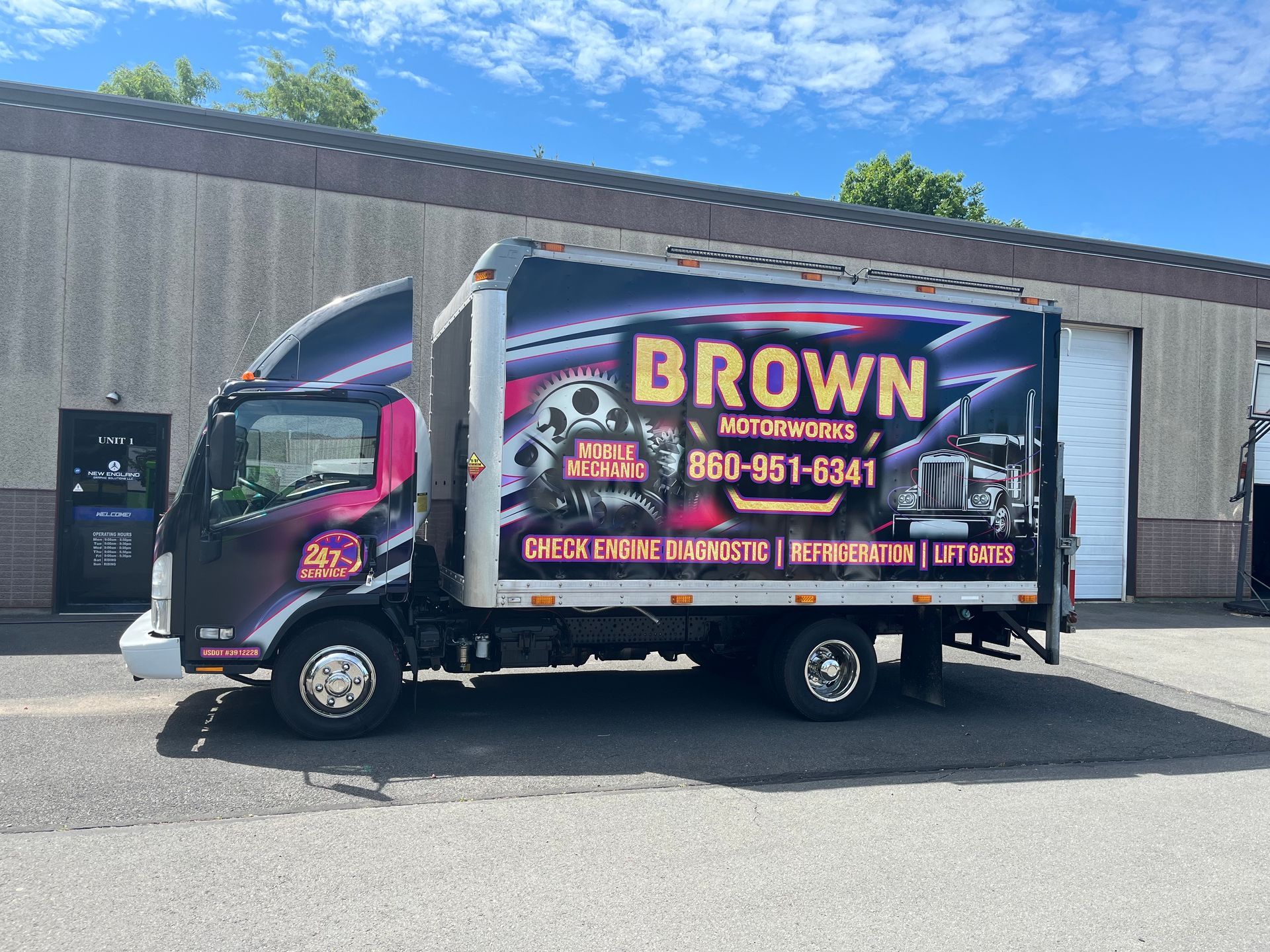 A brown truck is parked in front of a building.
