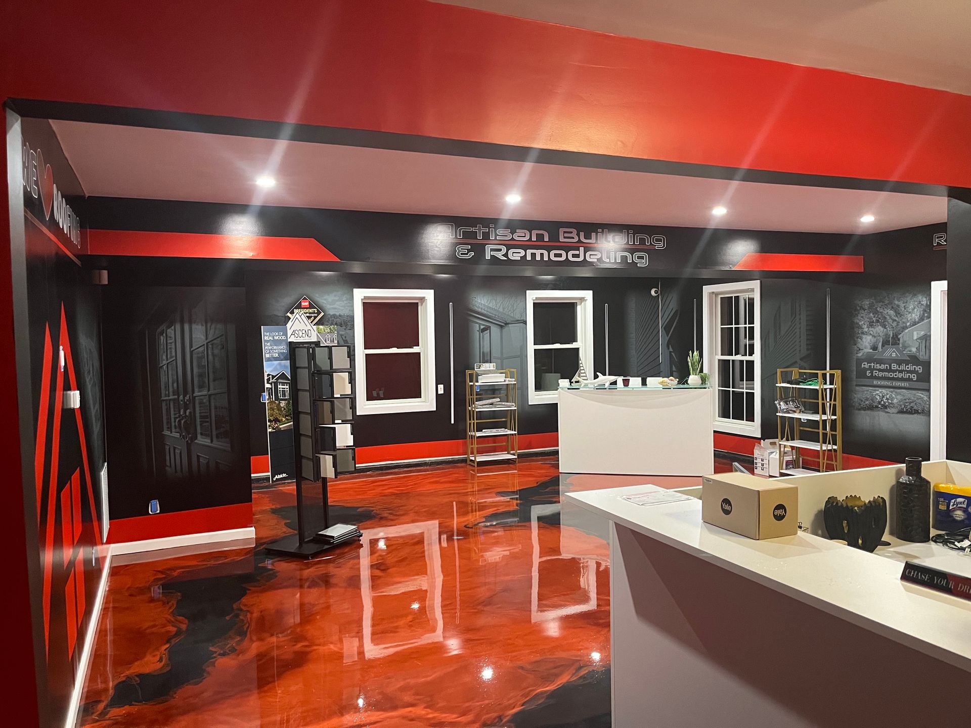 A room with a red and black floor and a white counter.