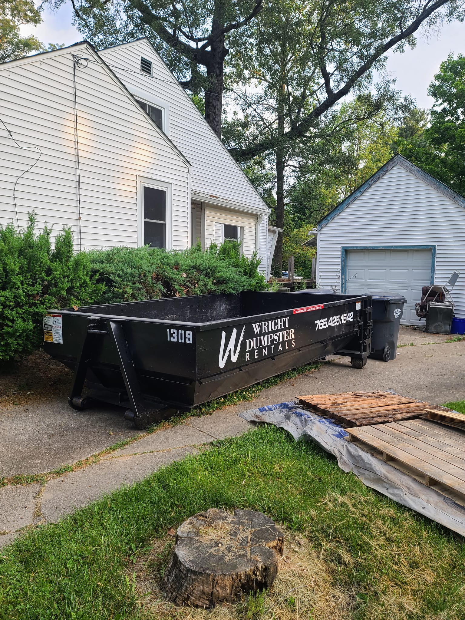 15 yard dumpster by a bush, best dumpster rental company near me, muncie, madison county in, wright dumpster rentals