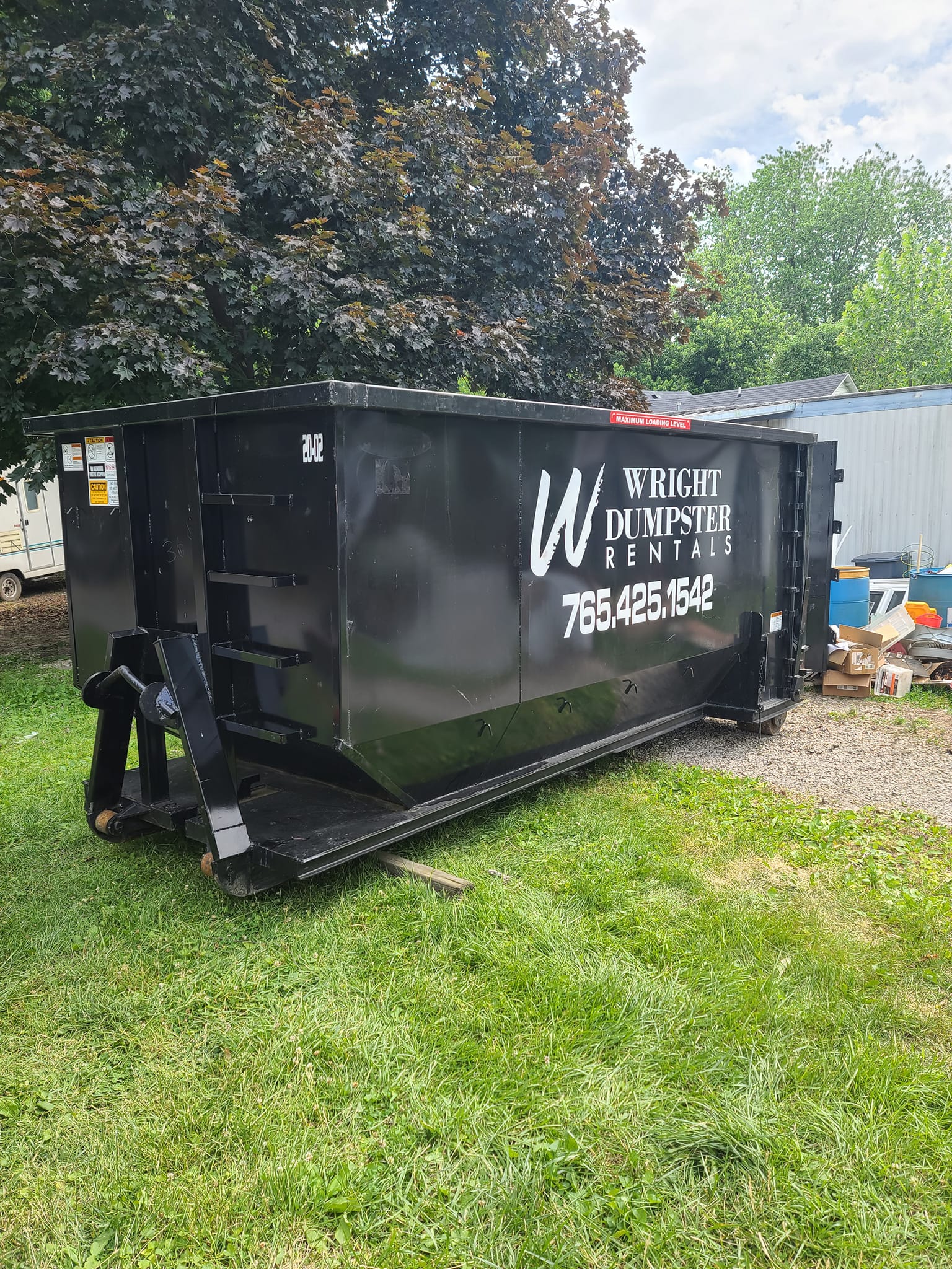 large black dumpster at house, customized dumpster rentals, best dumpster rental services near me, madison county in, wright dumpster rentals