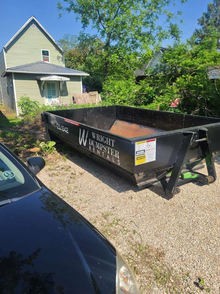 small black dumpster in back yard, fast, affordable dumpster rental services in madison county, wright dumpster rentals