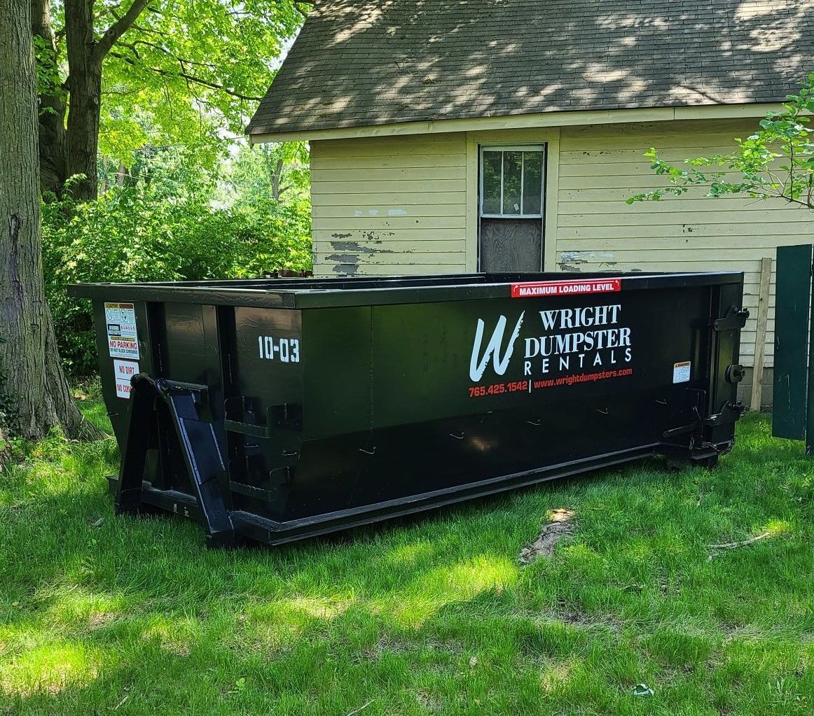 small black dumpster in front of garage, wright dumpster rentals, best dumpster rental company near me, madison county in