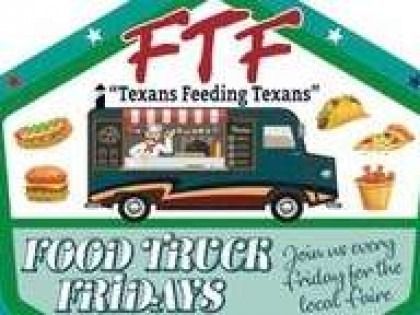 A food truck is parked in front of a sign that says `` texans feeding texans ''.