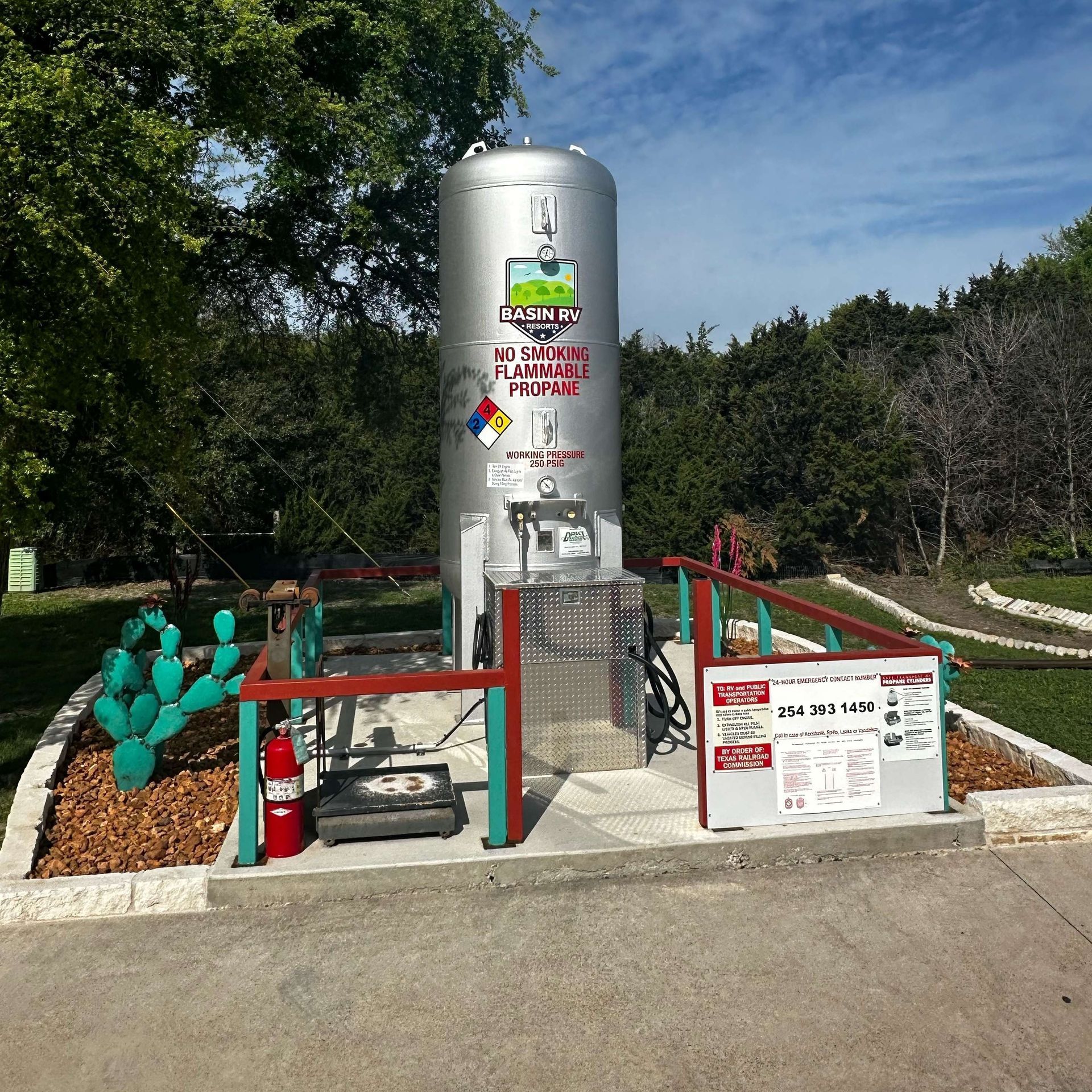 A large stainless steel tank with a warning sign on it