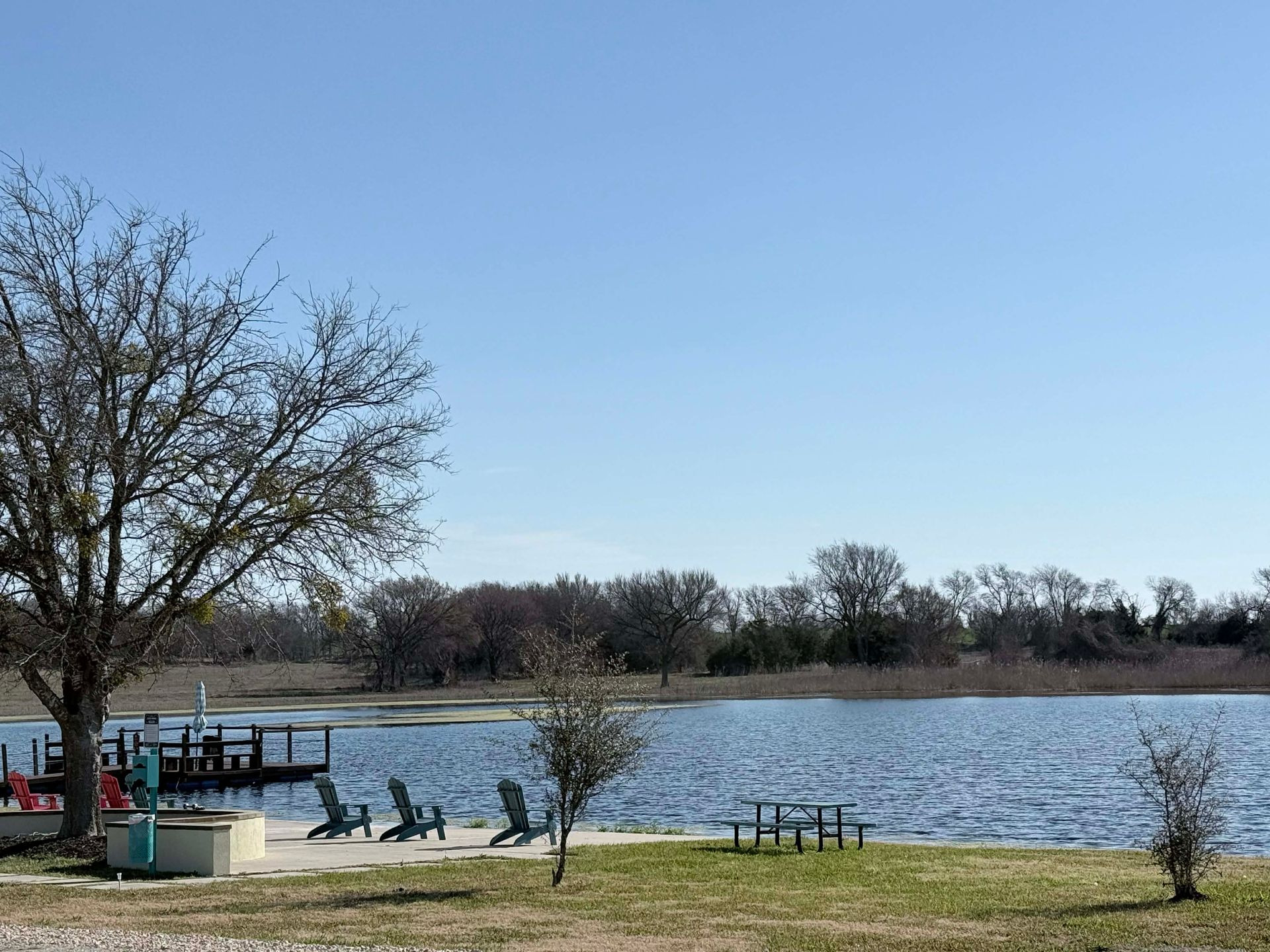 A patio area with a couch , chairs , table and television.