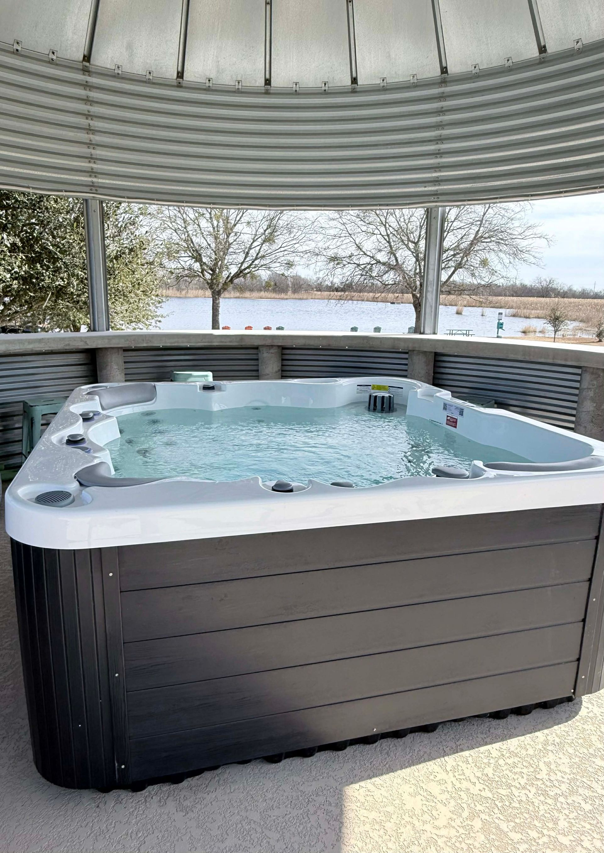 A bathroom with a texas flag shower curtain and a toilet.