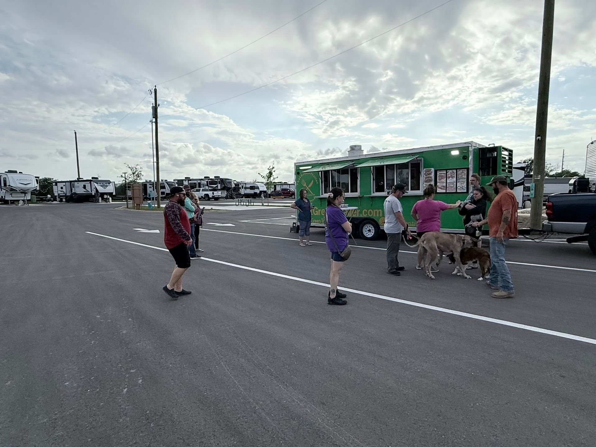 A patio with chairs and a ladder in front of a red building.