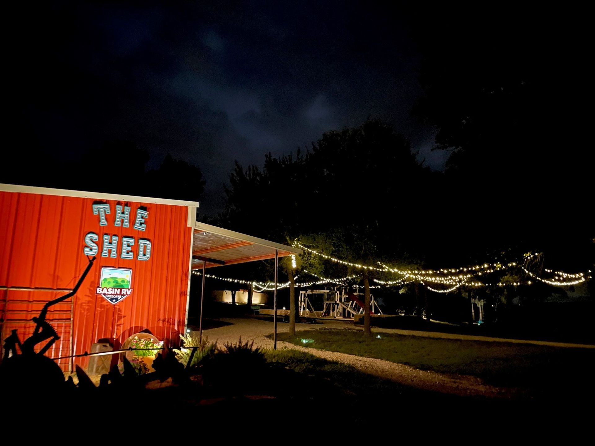 A red building with the words the shed on it
