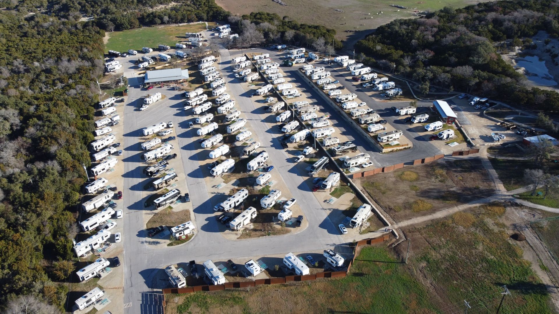 An aerial view of a rv park filled with lots of rvs.