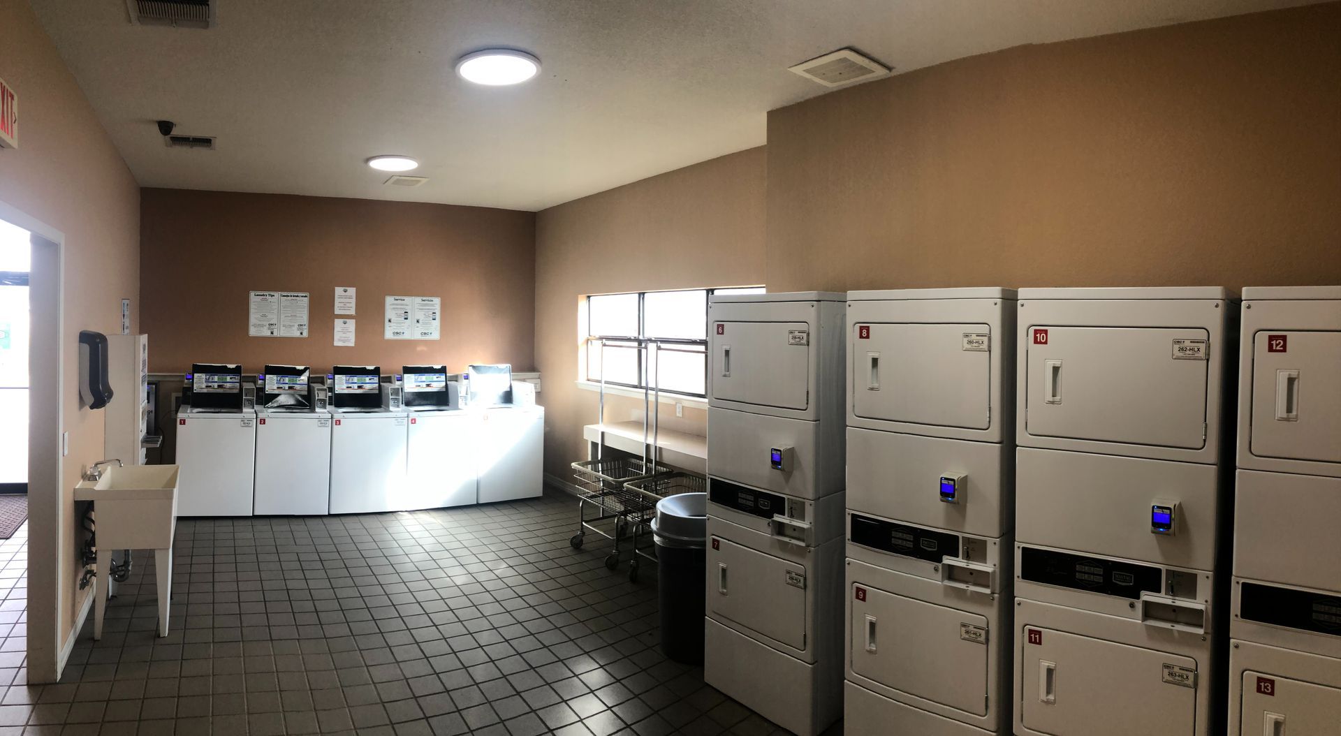 A laundromat with a lot of washers and dryers