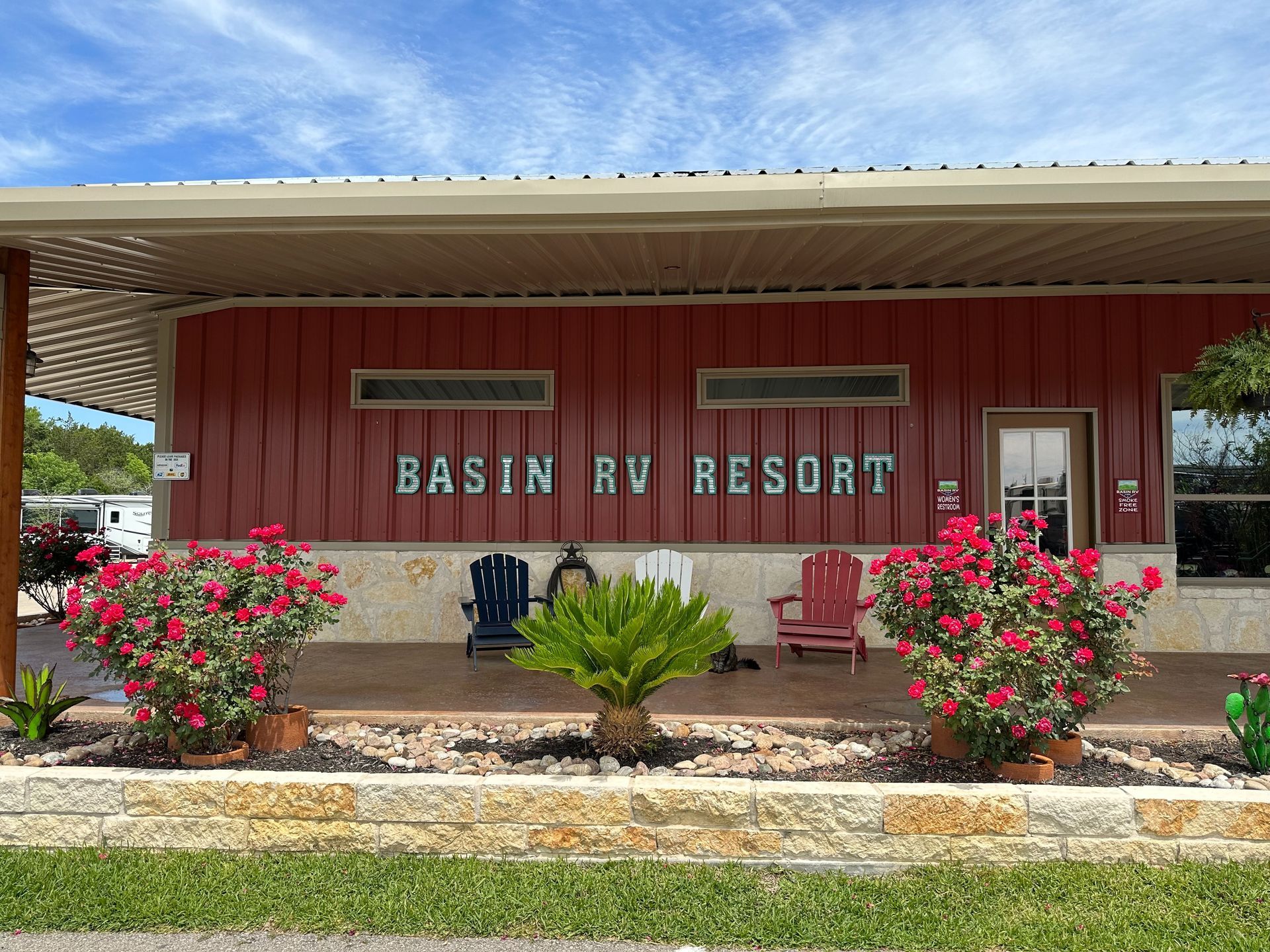 A red building with a sign that says basin rv resort