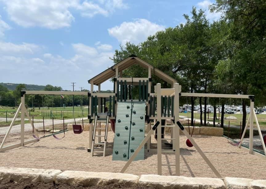 A playground with swings and a climbing wall