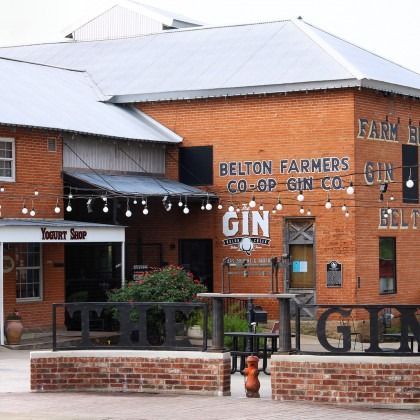 A brick building with a sign that says belton farmers co-op gin co