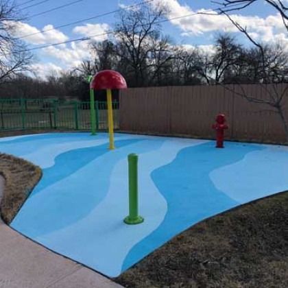 There is a fire hydrant in the middle of the water park.