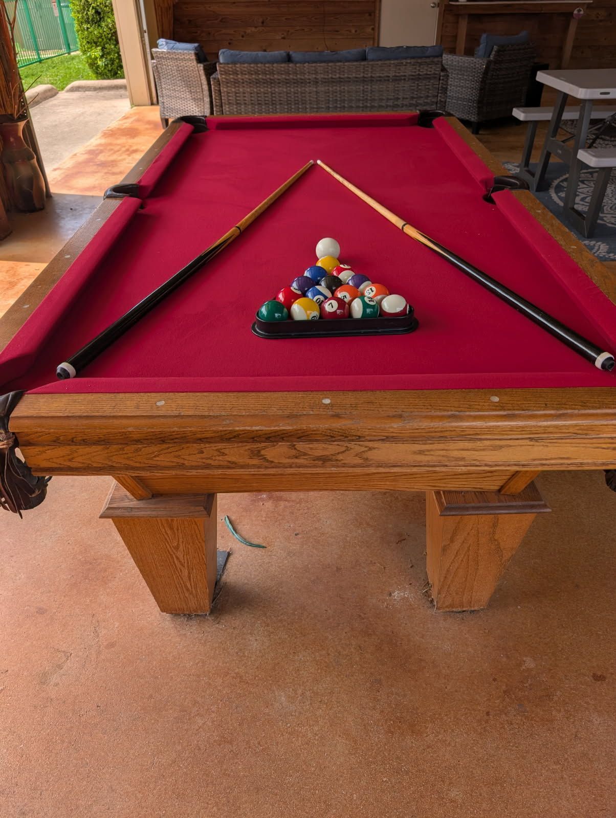 There is a pool table in the middle of the room.