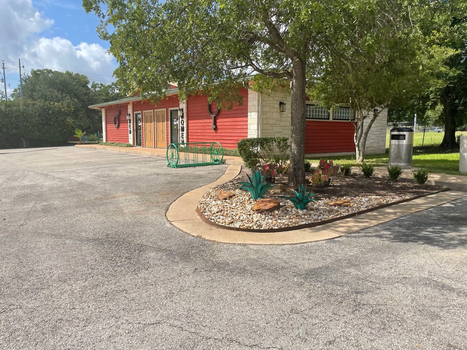 A red and white building with a parking lot in front of it.