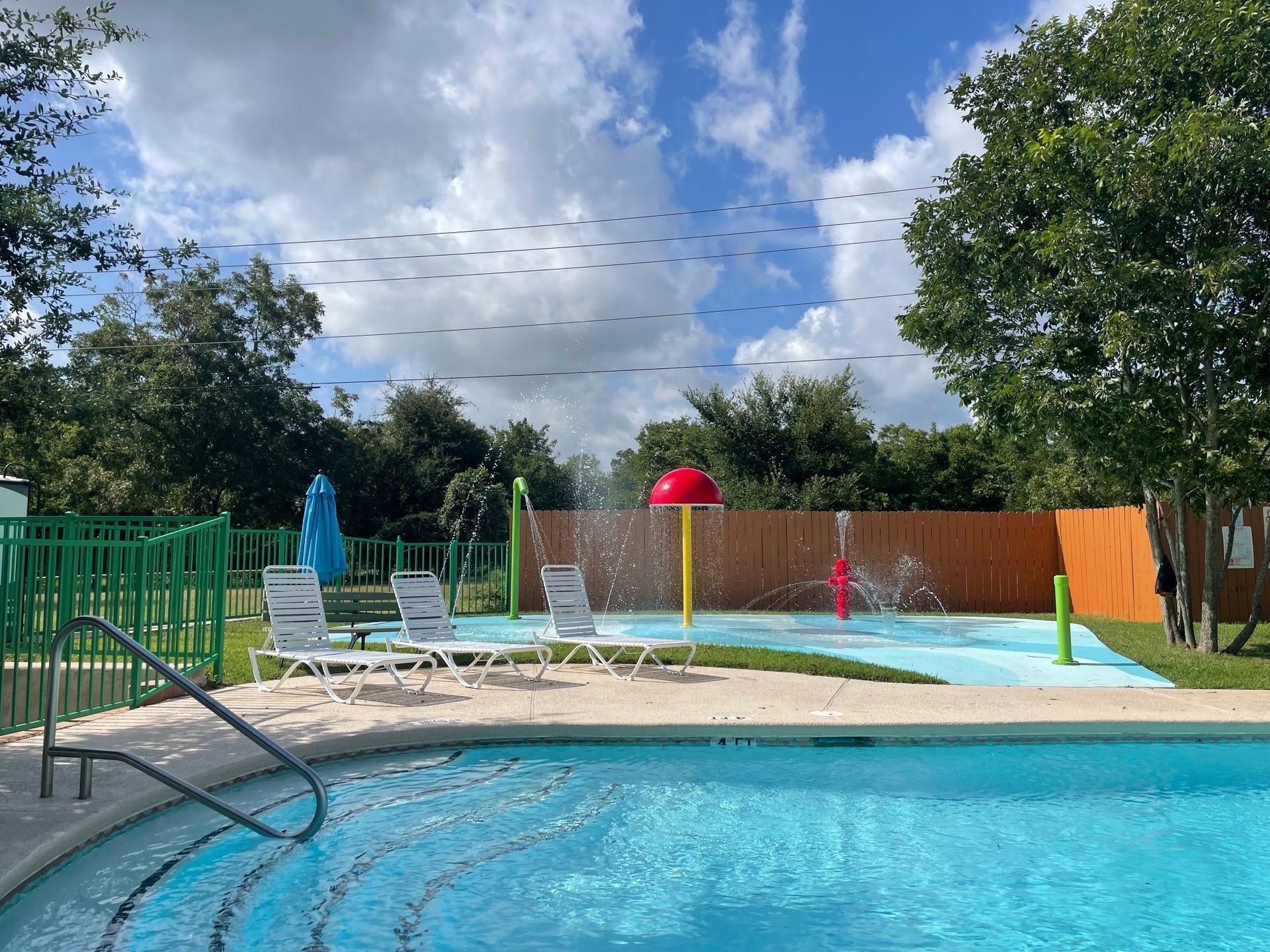 A large swimming pool with chairs and umbrellas around it