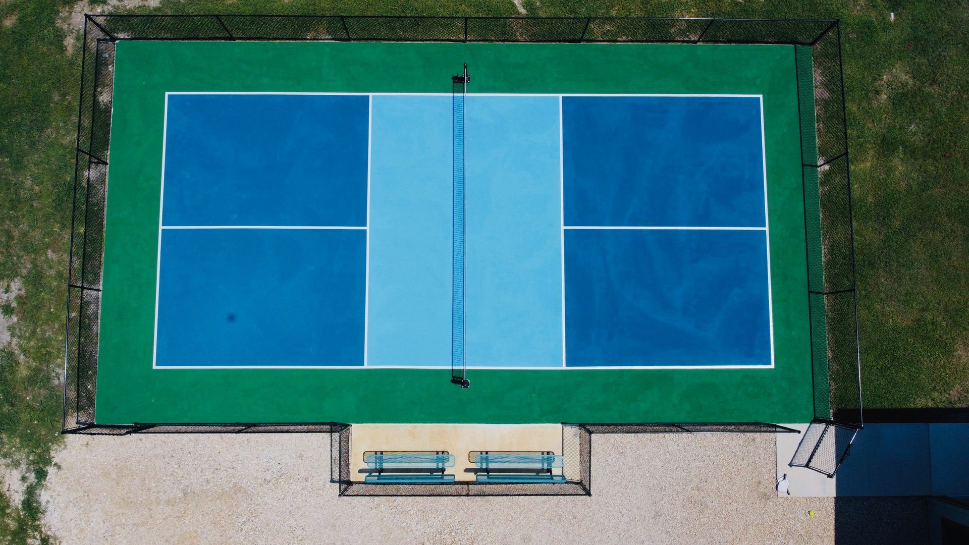 A patio with a lot of furniture and a television.