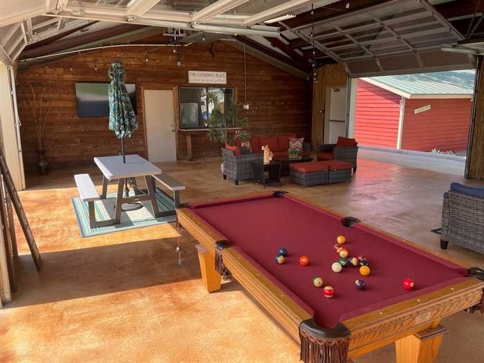 There is a pool table in the middle of the room.