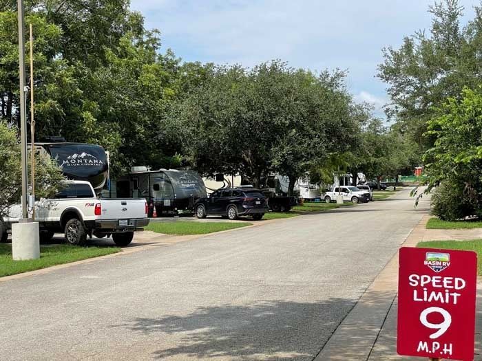 A speed limit sign is on the side of a road.