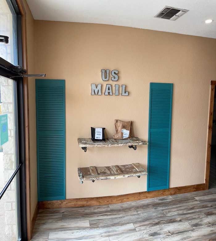 A room with a sign on the wall that says us mail