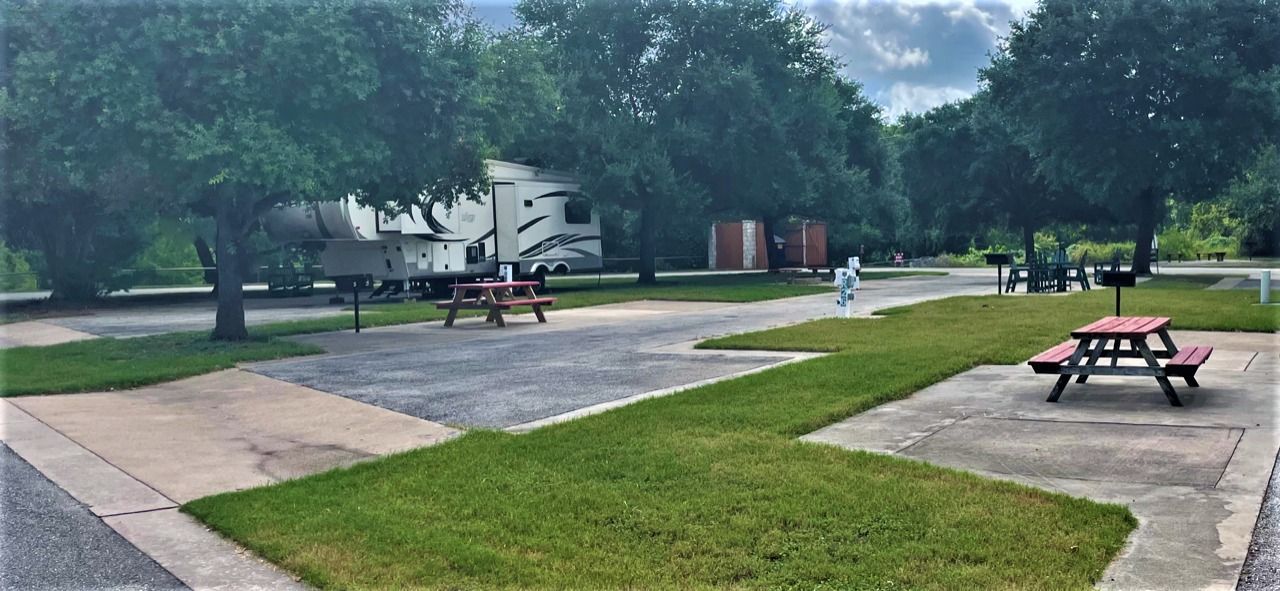 A picnic table is sitting in the middle of a park.