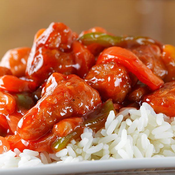 A plate of food with rice and sauce on it