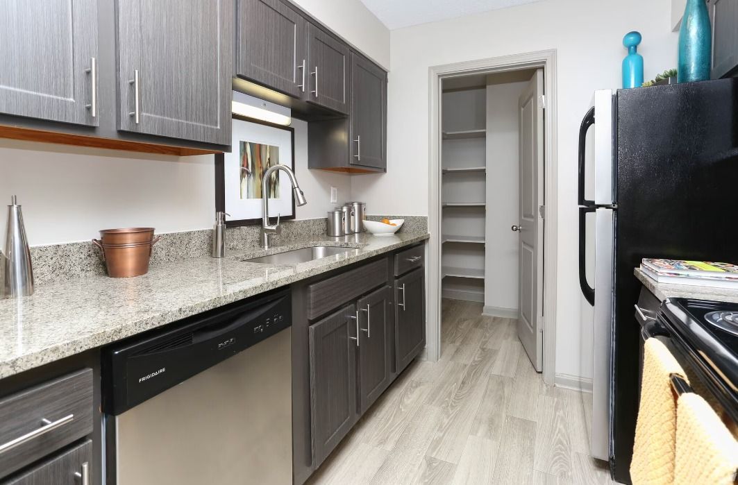 A kitchen with stainless steel appliances and granite counter tops.