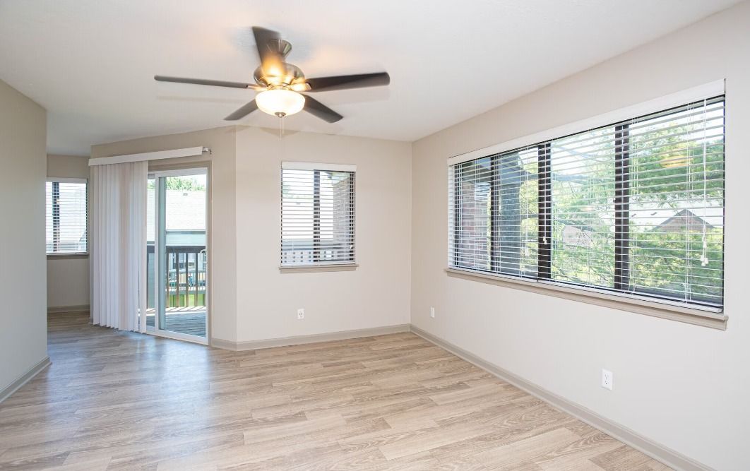 A large swimming pool surrounded by chairs and tables with umbrellas.